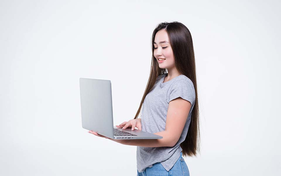 image of woman looking at her laptop to see how her website is doing